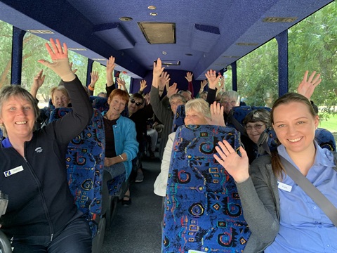 IMG_6392 Volunteers on bus waving.JPG